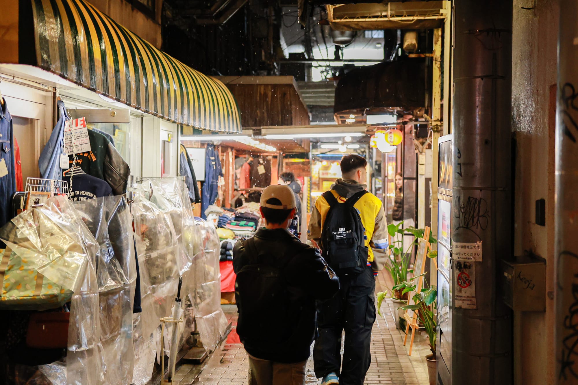 2 Japanese friends walking around a small street filled with shops and bars in Kichijoji, Tokyo.