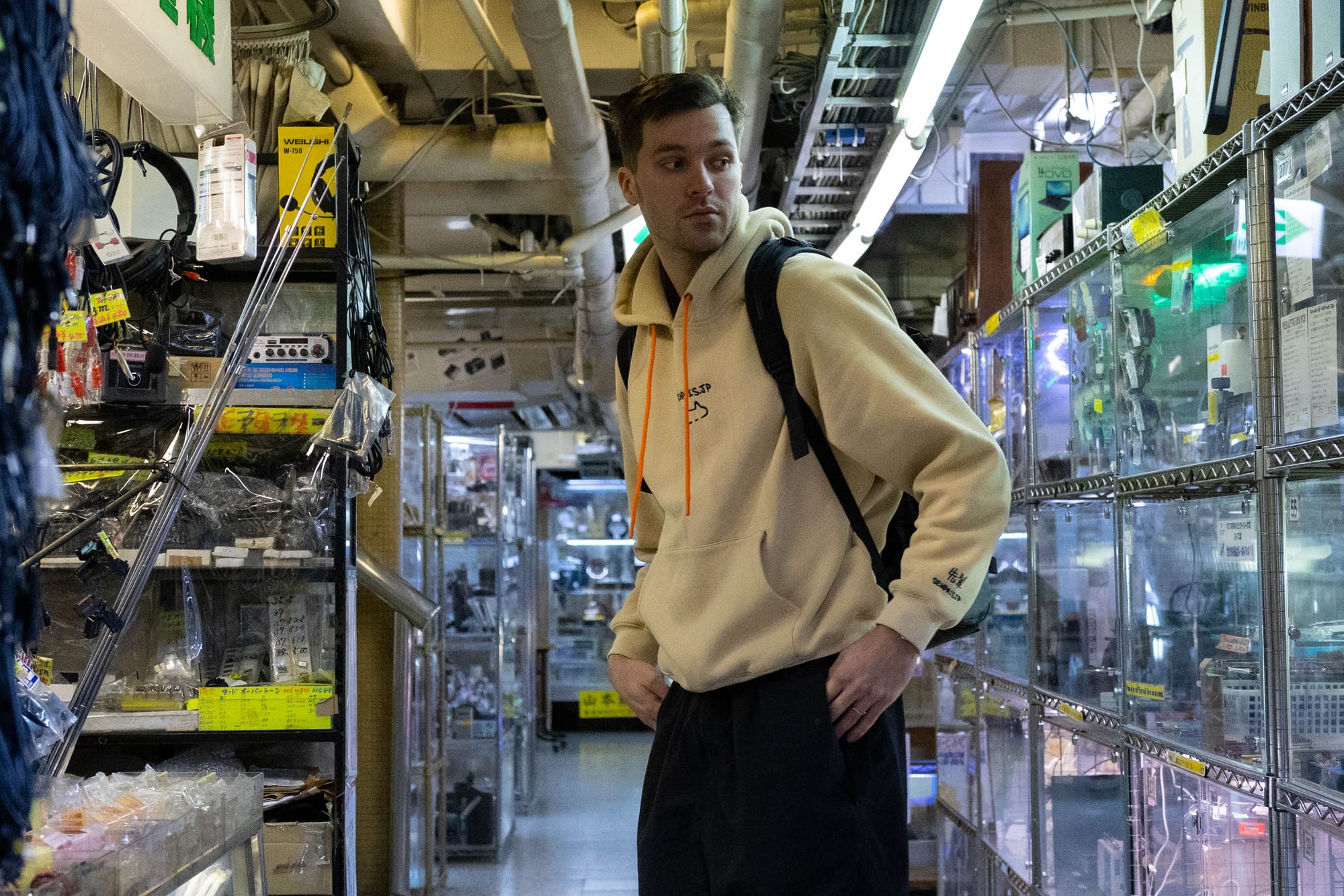 A young man looking at a retro video game store in Akihabara, Tokyo.