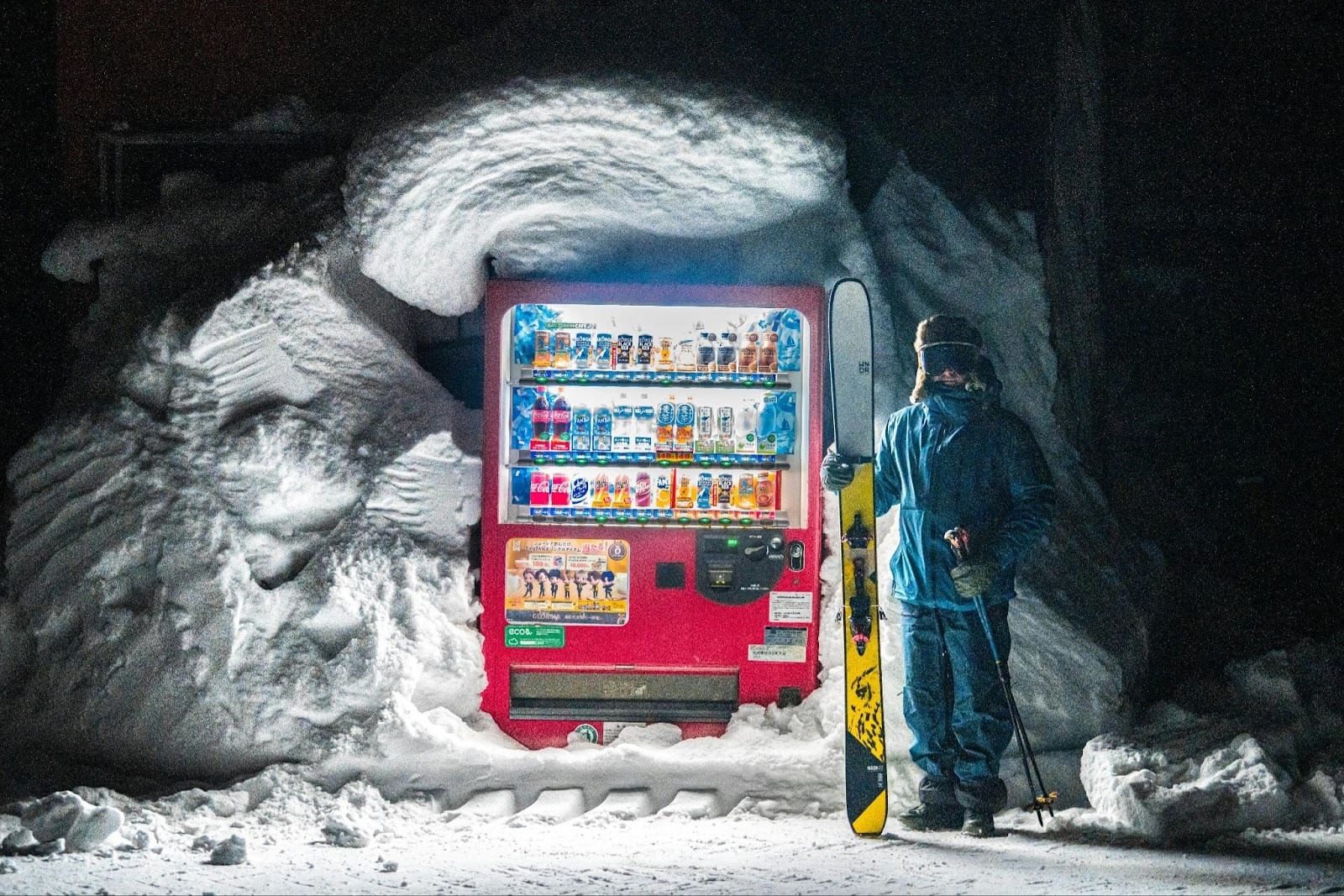 Person with Snowboard Posing by Vending Machine in Snow