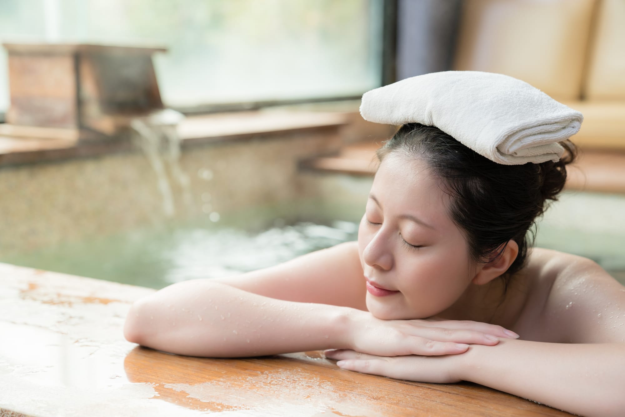 A woman relaxing in the onsen hot spring.