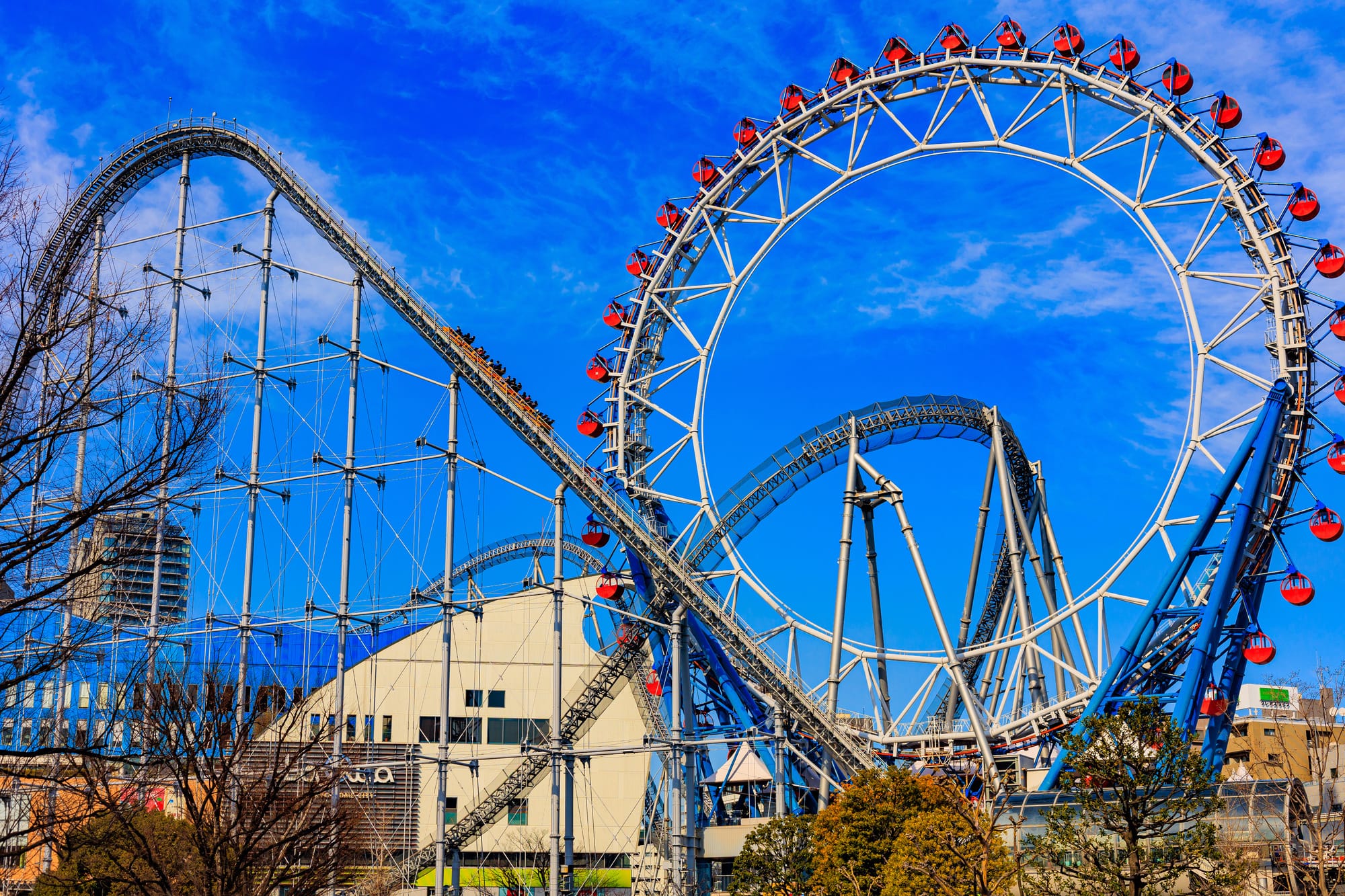 Roller coaster and Ferris wheel at Tokyo Dome City.