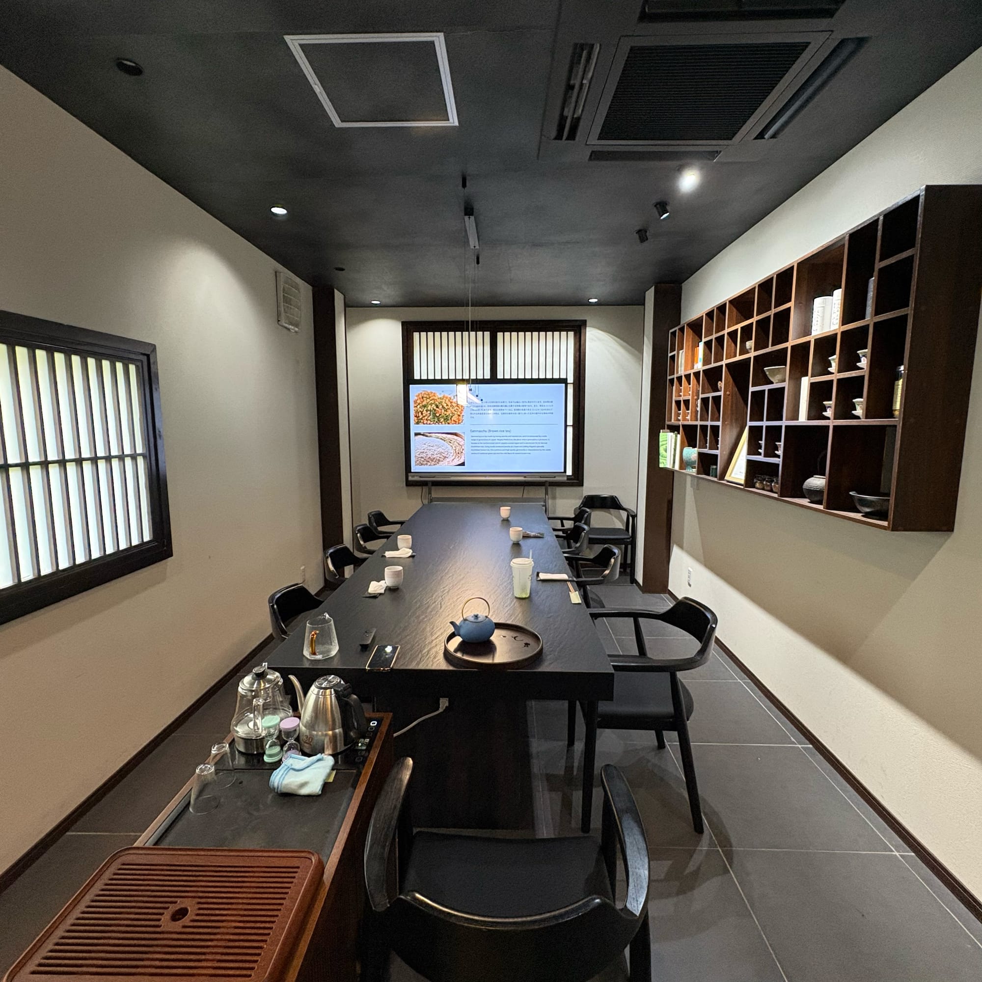 Modern tea ceremony room with tables and chairs at OCHARU in Tokyo
