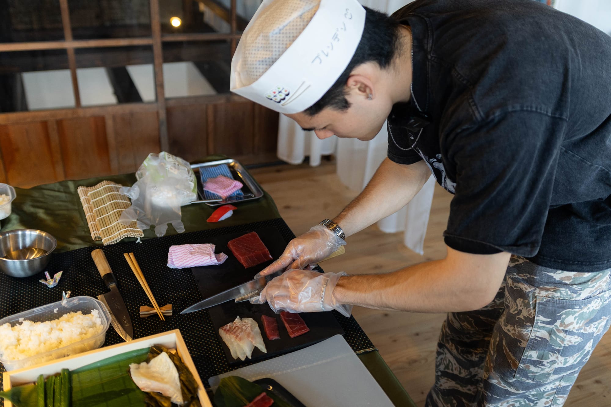 Slicing fresh sashimi using a sashimi knife to make our own sushi