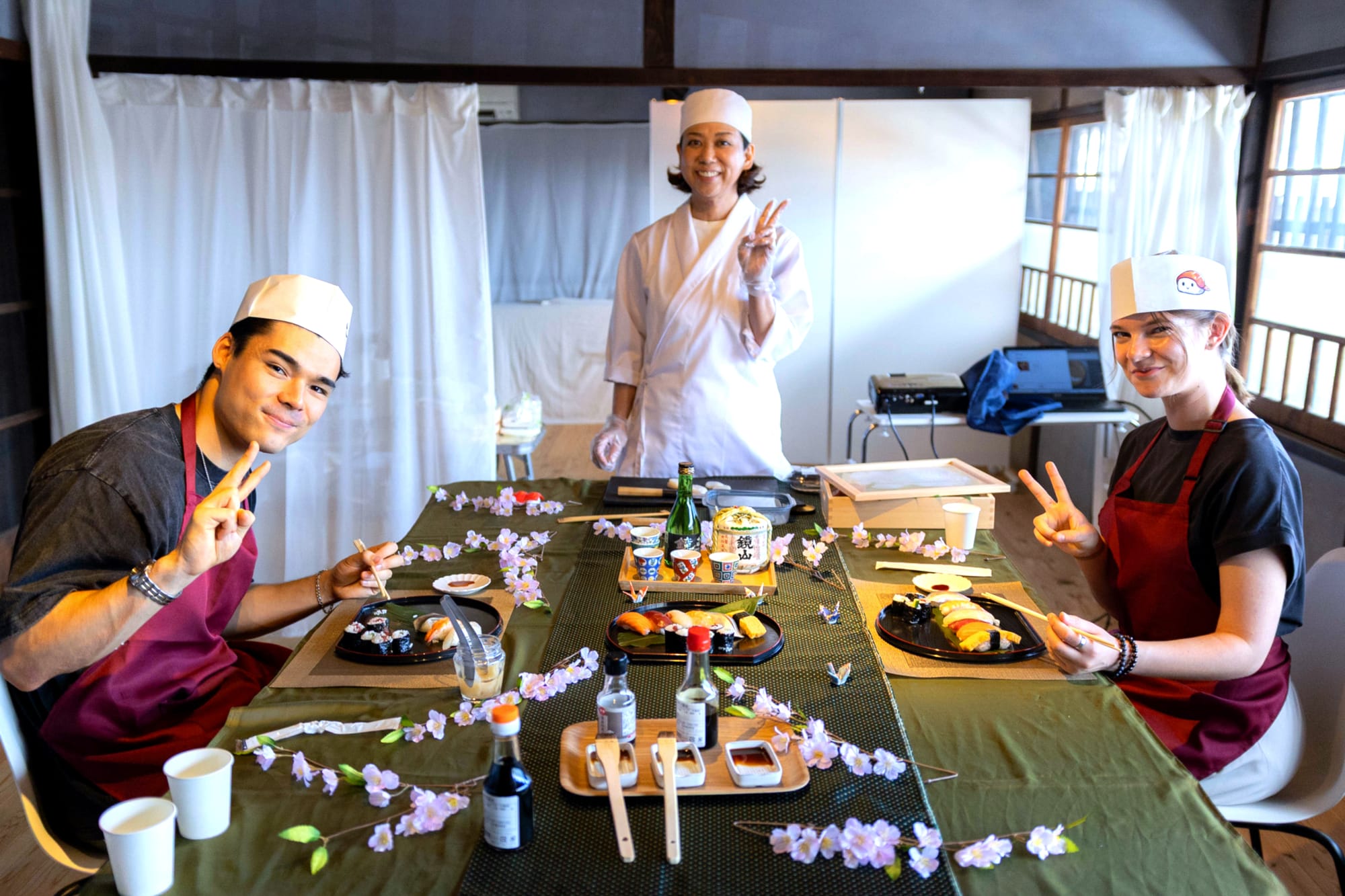 Complete sushi making experience complete with traditional sake and sakura