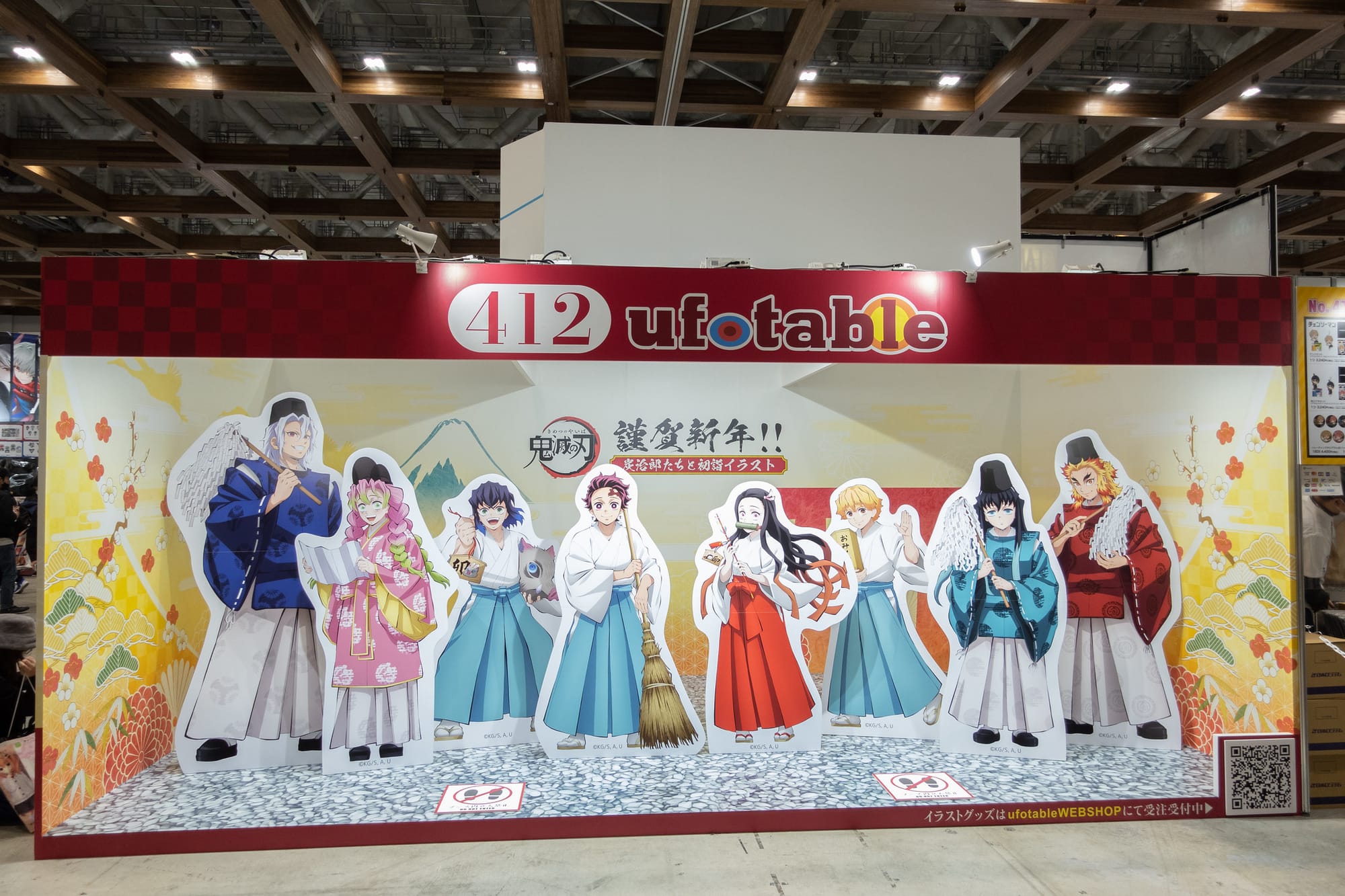 A life-sized diorama featuring standees from the anime series Demon Slayer at the animation studio ufotable's booth at Comiket