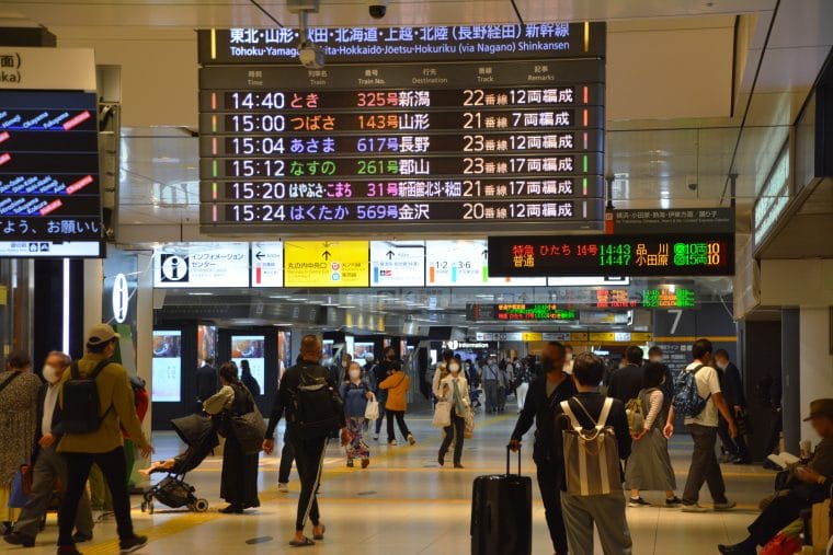 People walking in different directions at a Shinkansen bullet train station in Japan