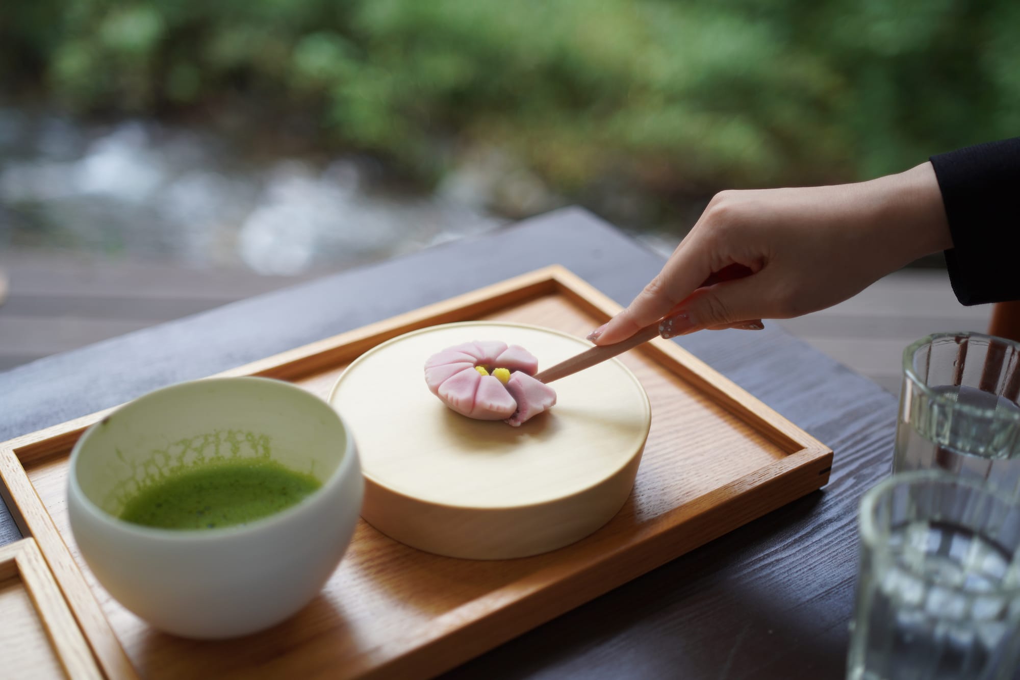Matcha tea and traditional Japanese wagashi served on a wooden tray in Tokyo