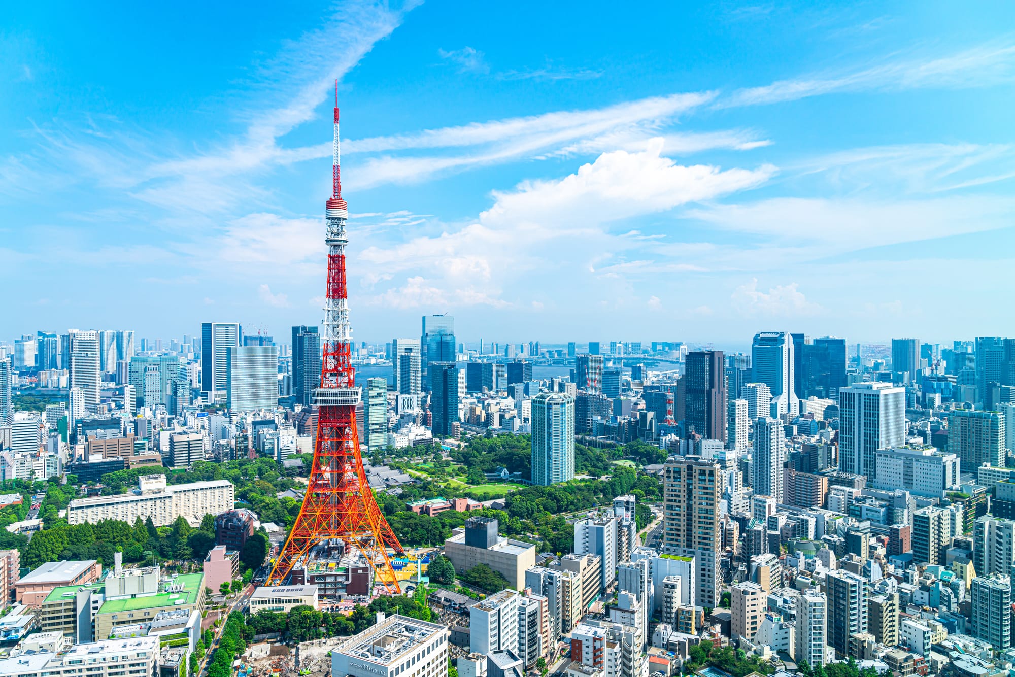A view of Tokyo city with Tokyo Tower standing out among the many tall buildings.