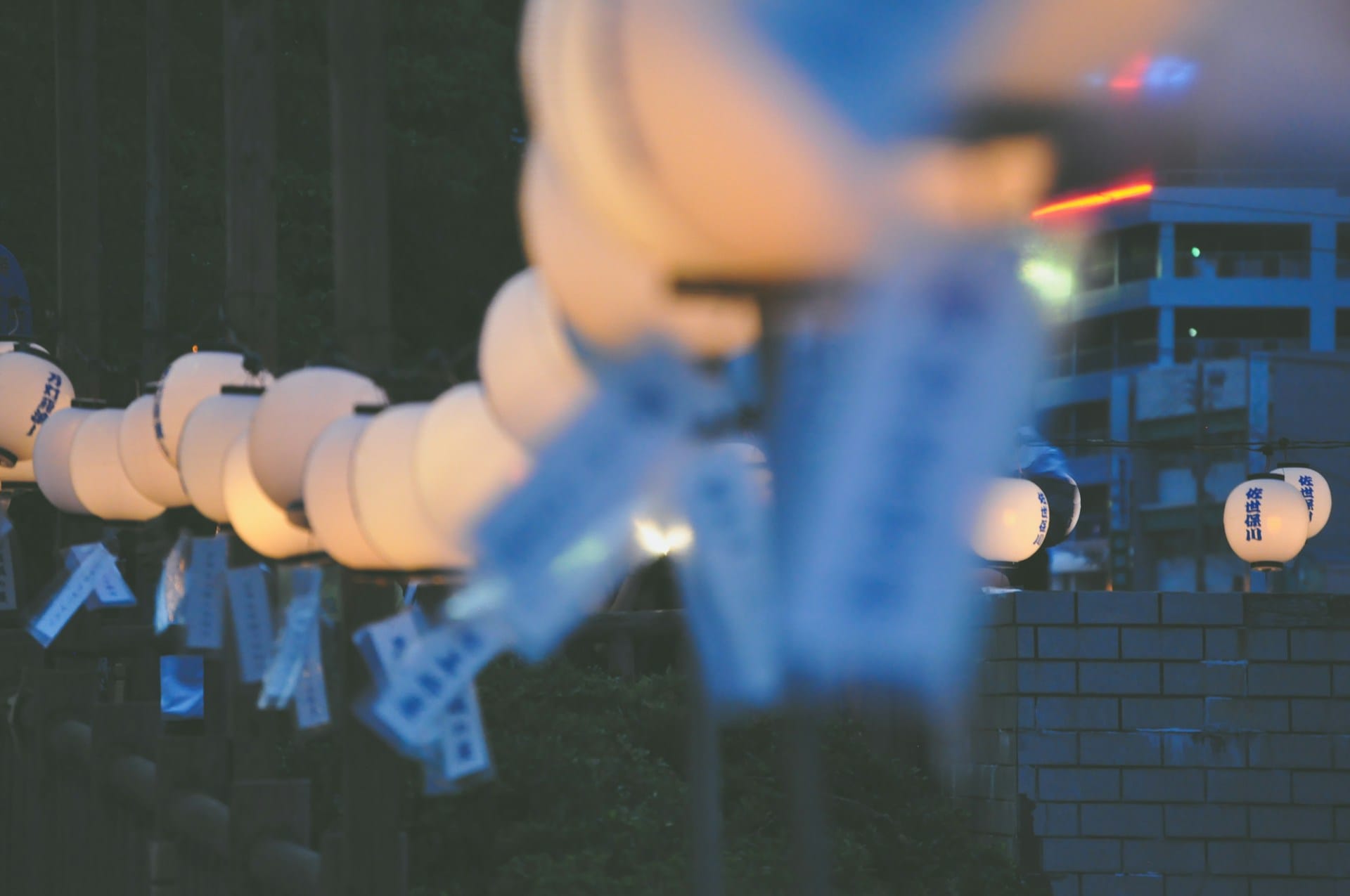Lit-up lanterns for Obon hanging at a neighborhood in Japan