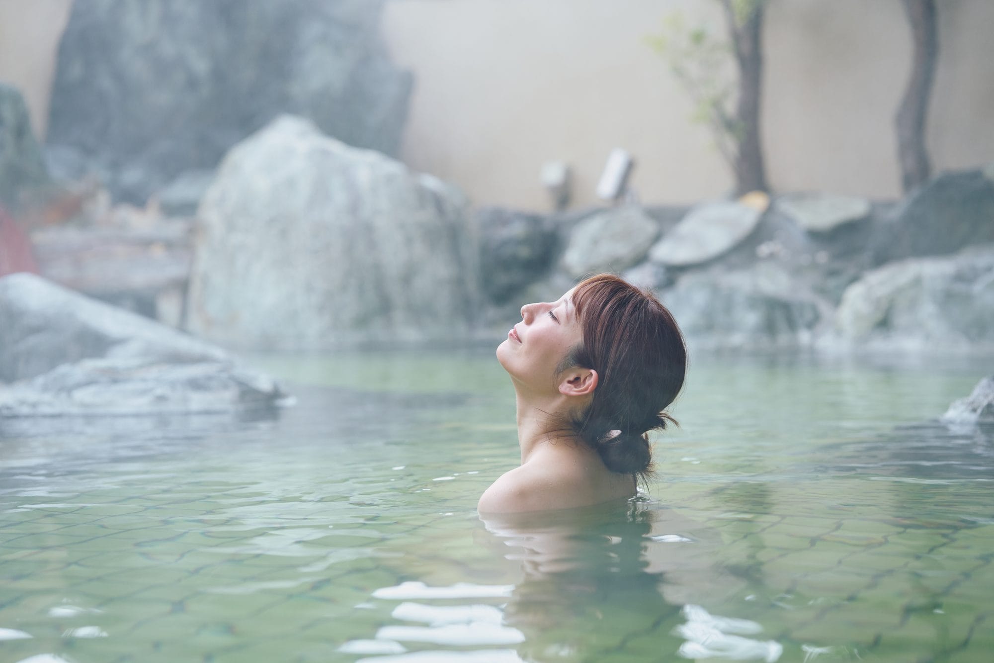 A woman enjoying the hot spring in Japan.