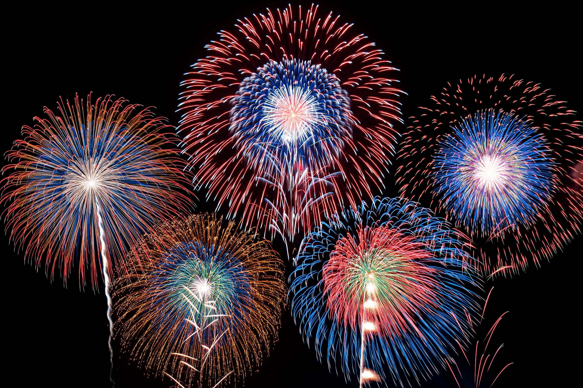 A large display of colorful fireworks at a festival in Japan