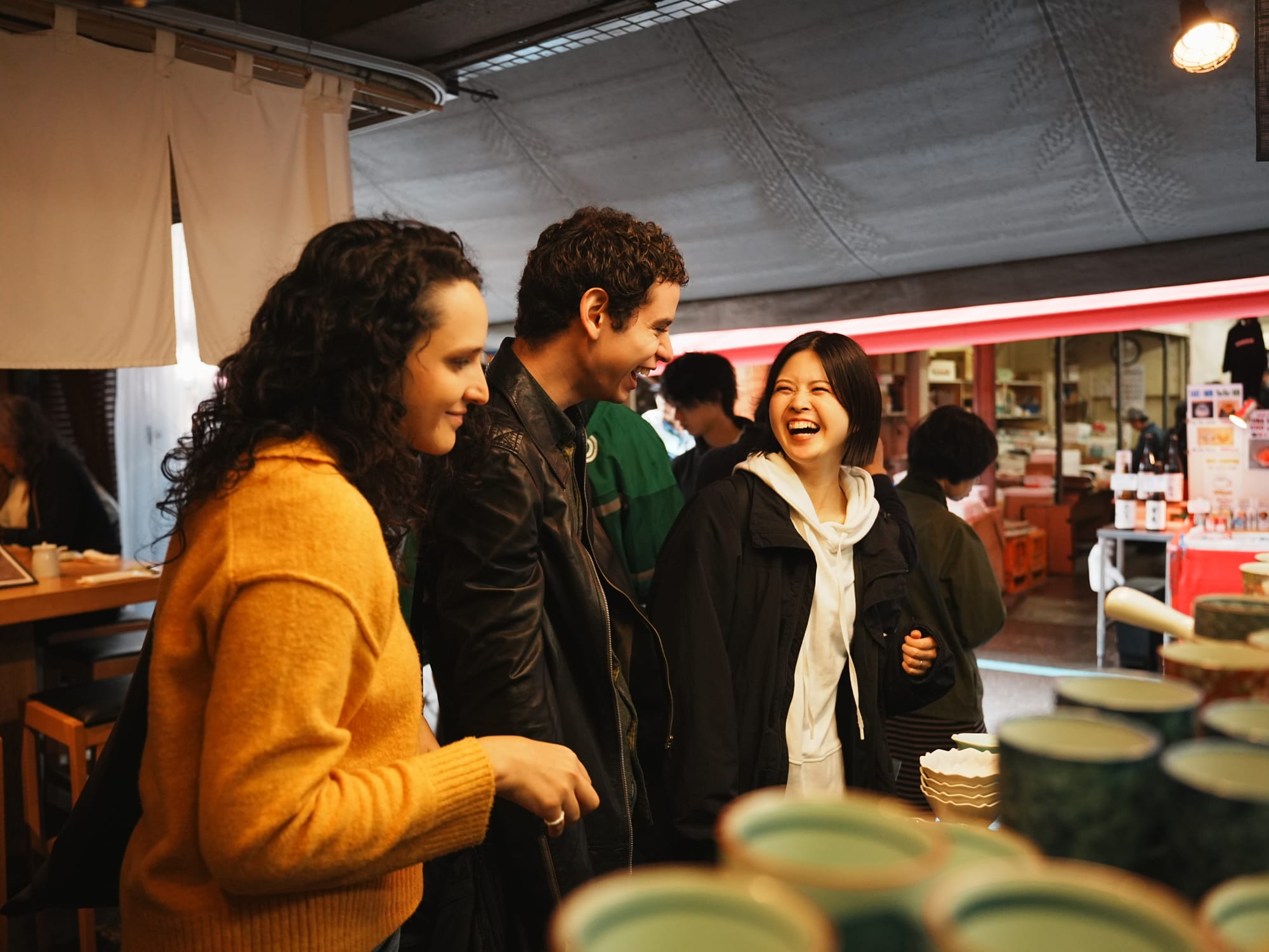 A Japanese tour guide shares a laugh with a couple on their tour 