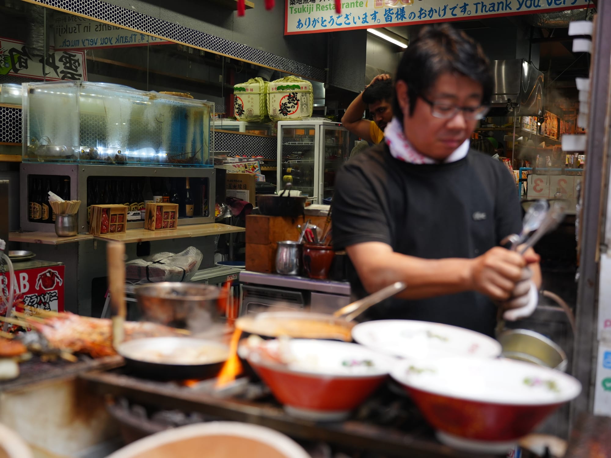 A chef preparing a variety of Japanese dishes