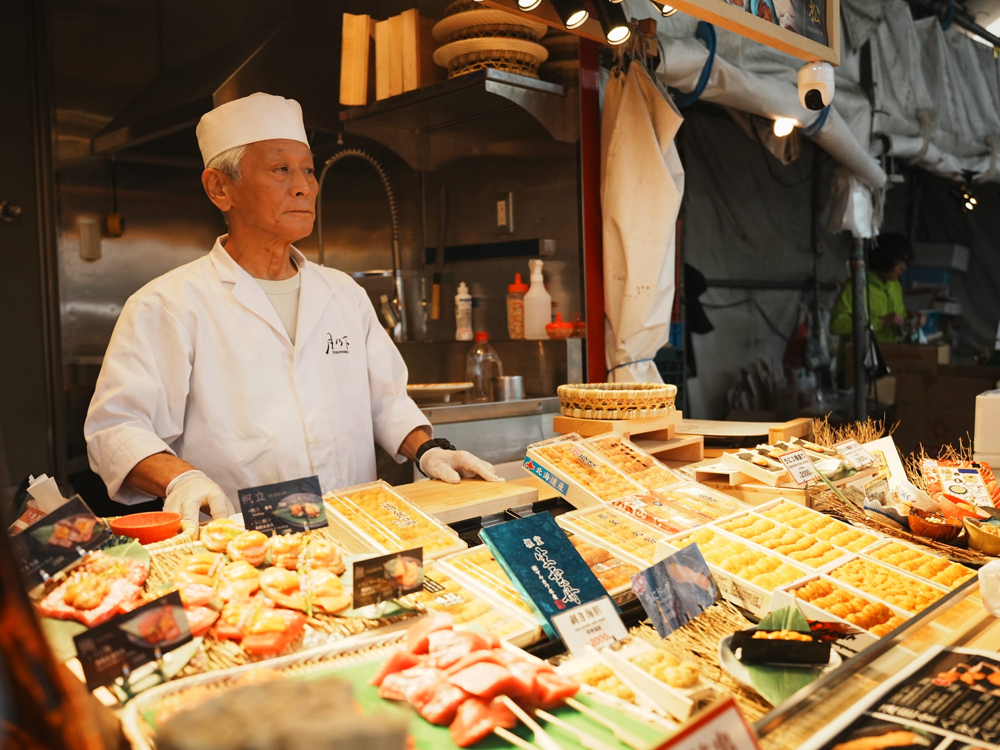 A vendor in Tsukiji displaying a variety of seafood