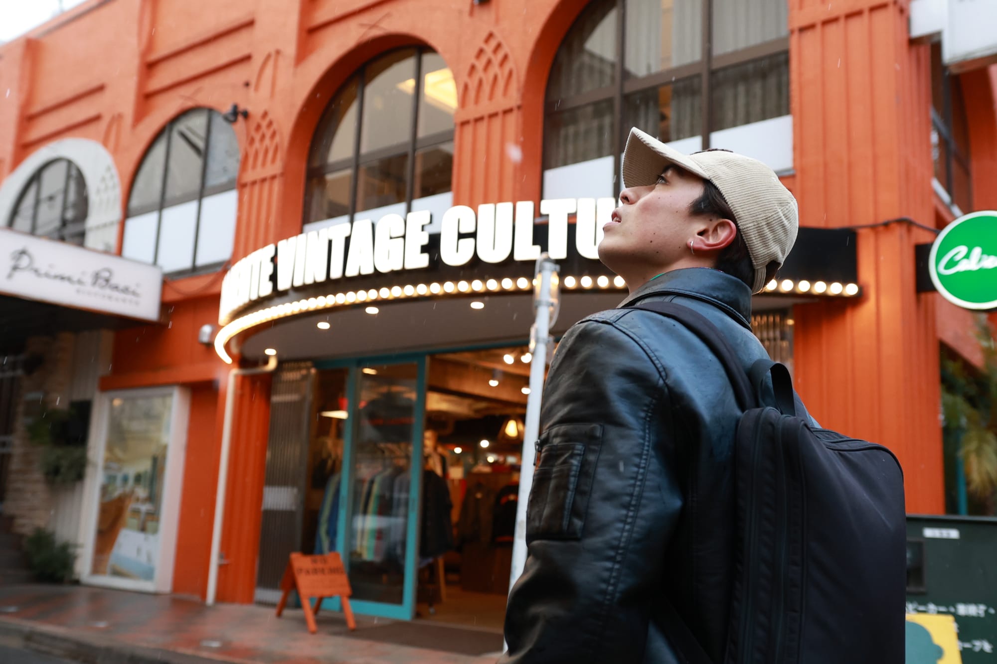 A Japanese young man looking around a street full of shops in Kichijoji, Tokyo.