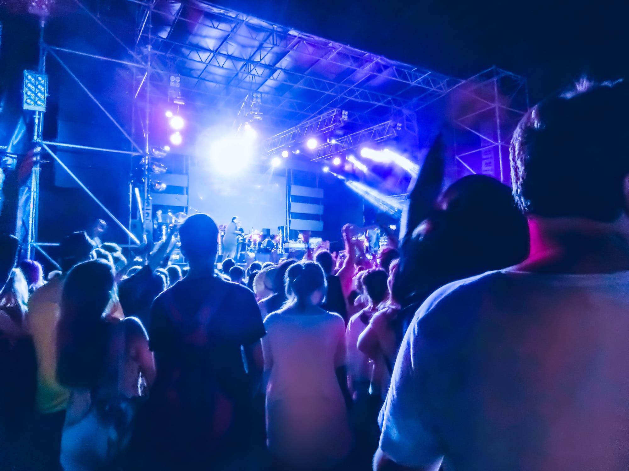A large group looking at a a band performing on stage