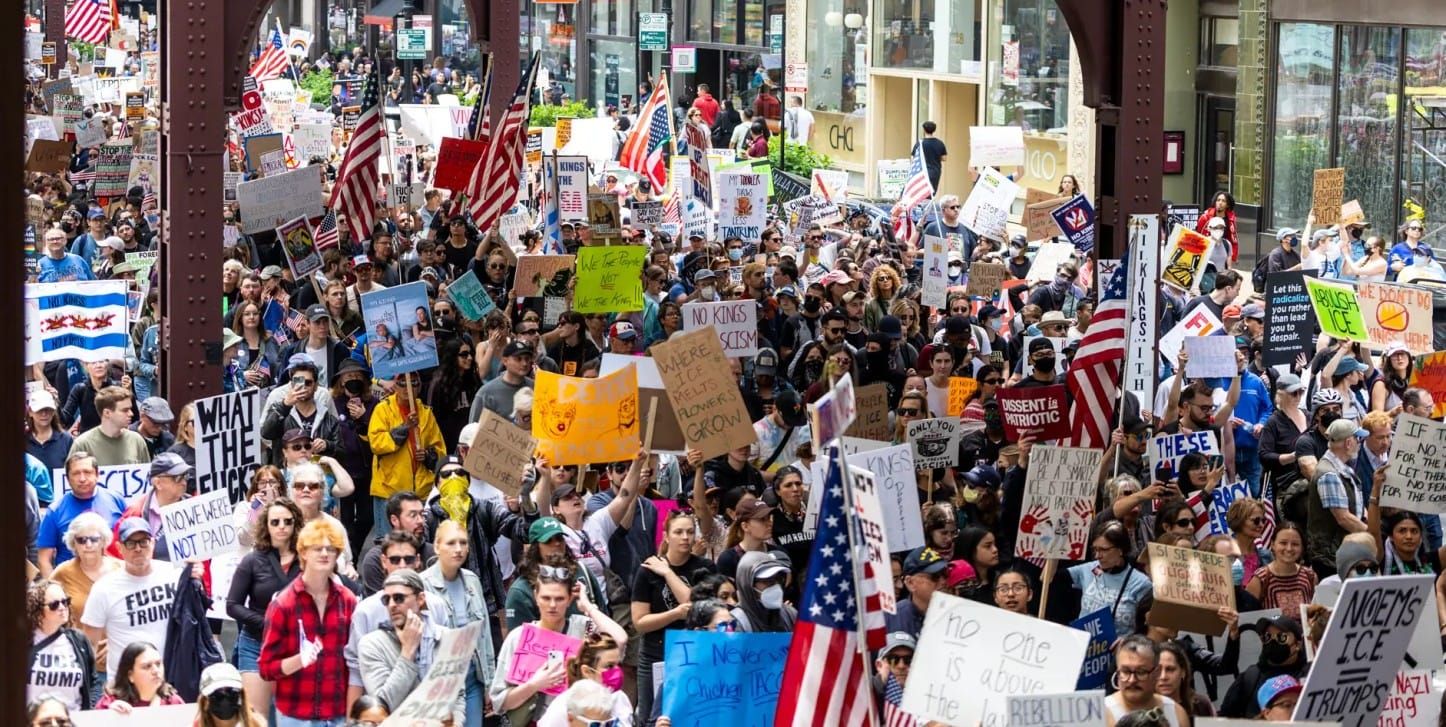 Several hundred people from Chicago's “No Kings” protest and march, attended by tens of thousands, make their way north on Wabash Street, under the "L" train