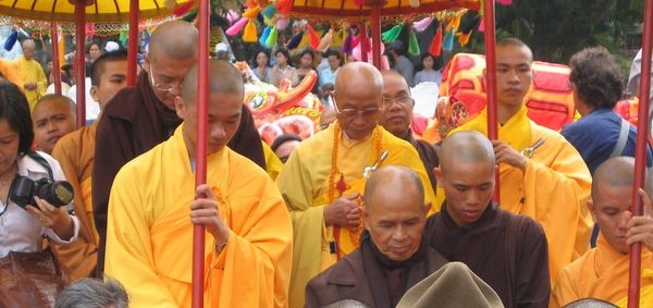Thich Nhat Hanh in a colorful procession with yellow-clad Buddhist monks at 2007 festival in Da Nang, Vietnam