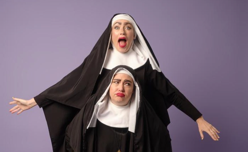 Two women in black robes and white headscarf holding a person on their back

Description automatically generated