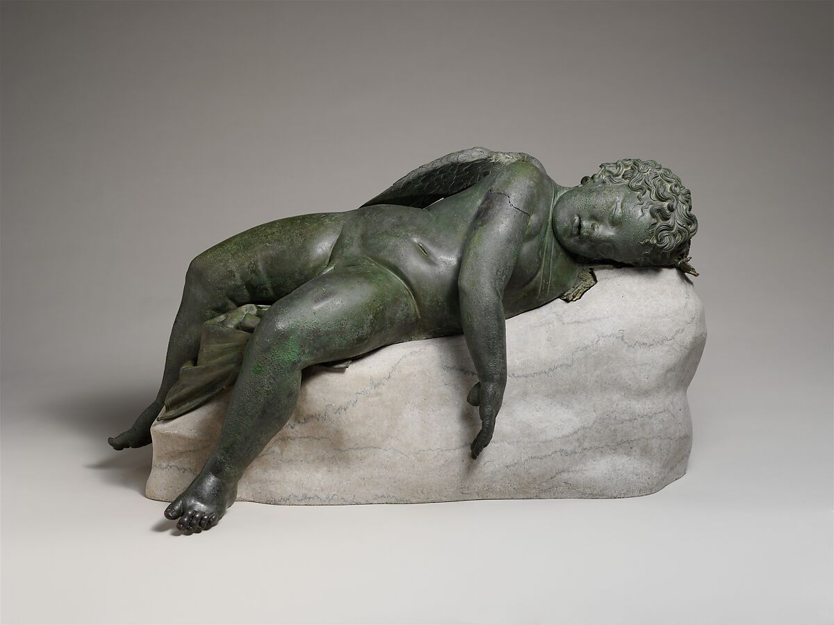 A statue of a sleeping angel
Description automatically generated