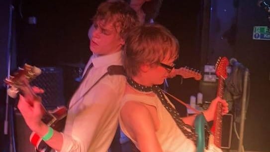 A group of people playing instruments

AI-generated content may be incorrect.