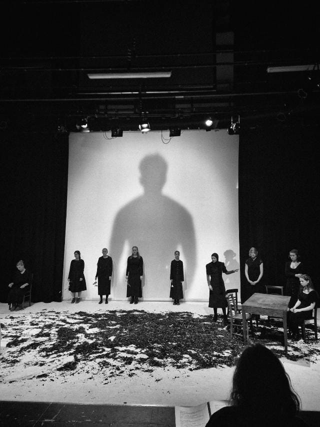 A group of people standing in front of a large shadow

AI-generated content may be incorrect.