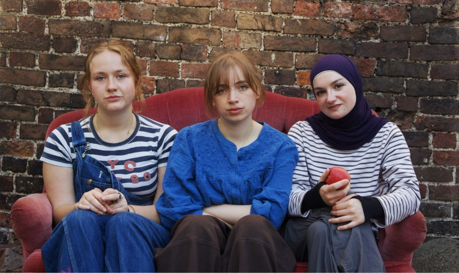 A group of women sitting on a couch

Description automatically generated