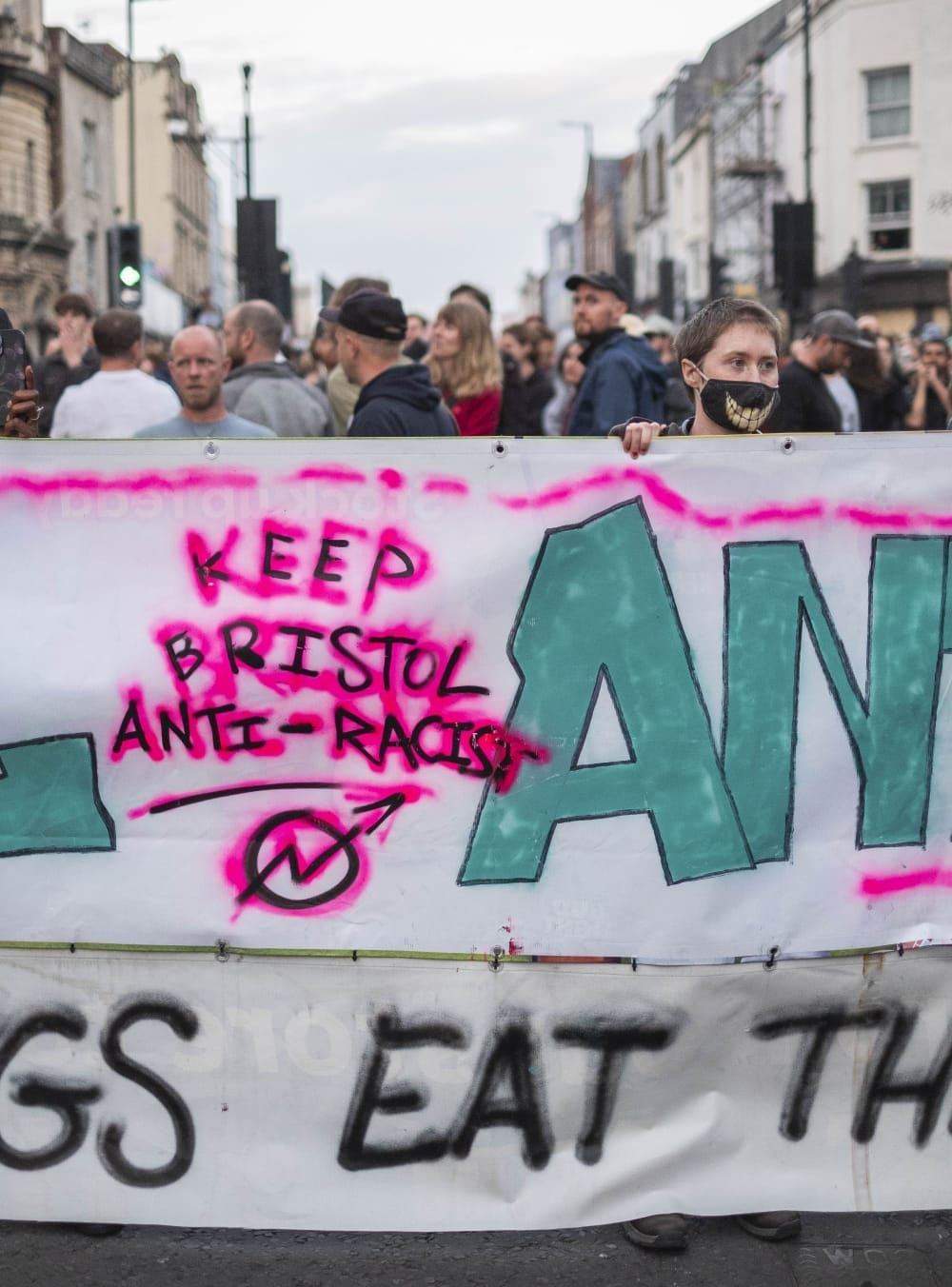 Person holding sign that reads 'KEEP BRISTOL ANTI-RACIST'