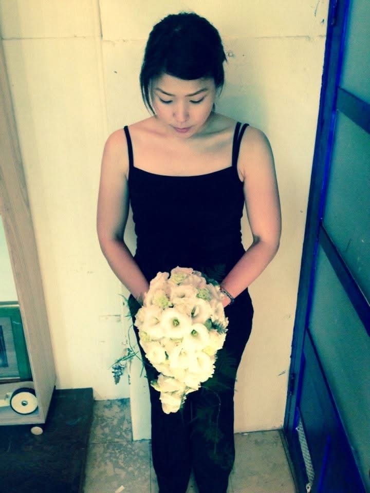 Ryoko holding her first bouquet at the flower shop in 2012