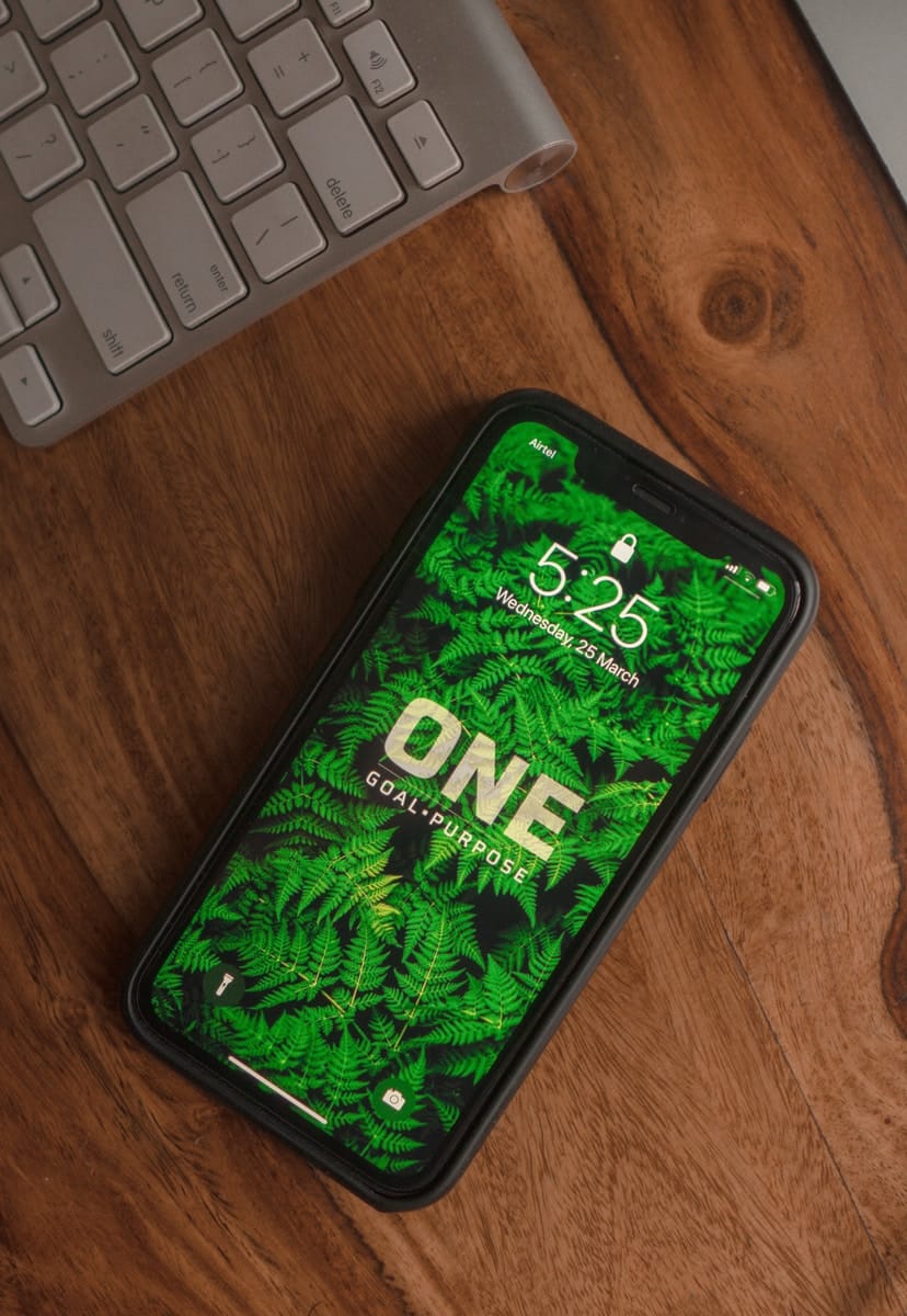 black and green android smartphone on brown wooden table