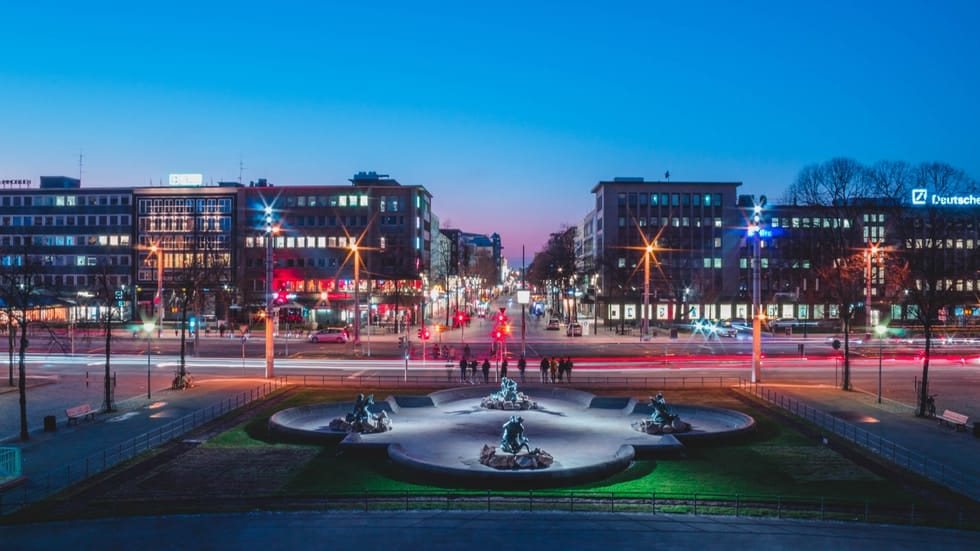 water fountain in the middle of the city during night time