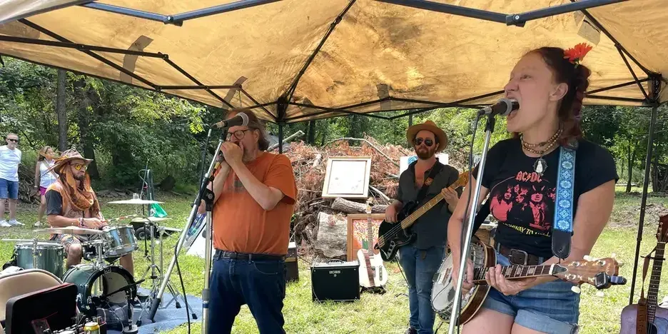 a band performing under a tent outdoors
