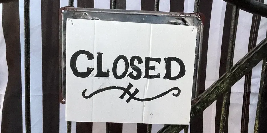 a fancy, hand-written sign that says closed