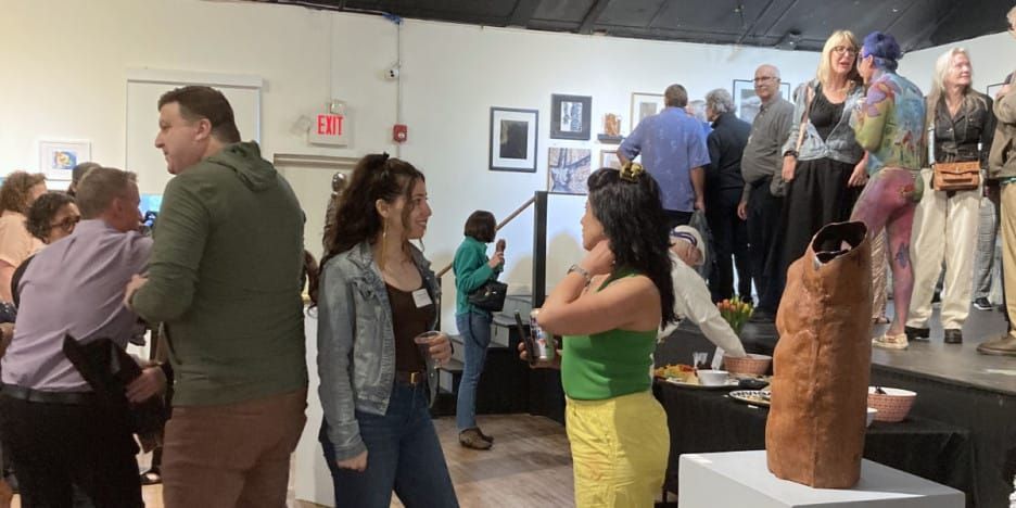 people gather and look at art at the New Hope Arts gall