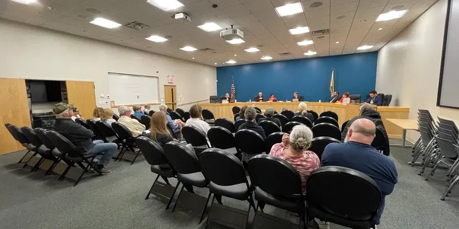 people gathered in seats at the meeting