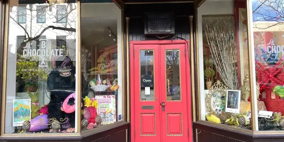 posters in the window of a quaint chocolate shop