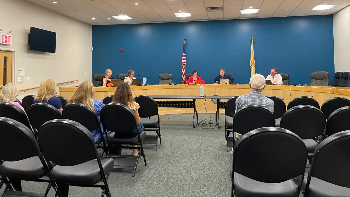 council members sitting at the dais, community members sit in chairs facing them