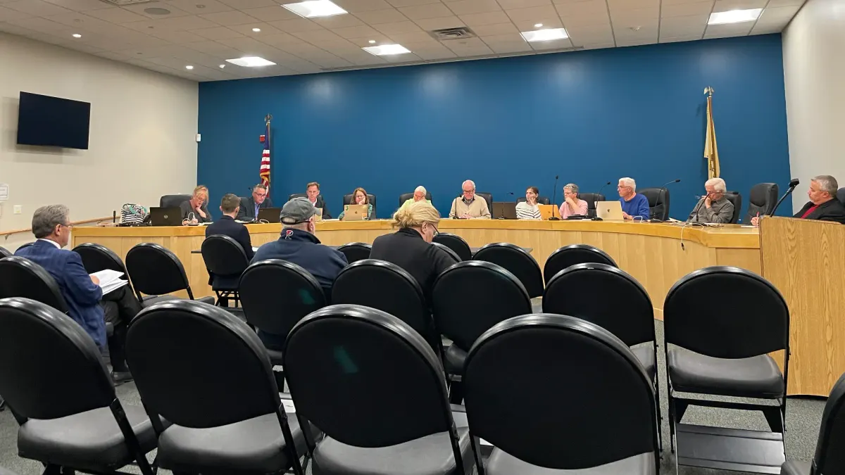 Planning Board members sitting at the dais with several people sitting before them in community seating area