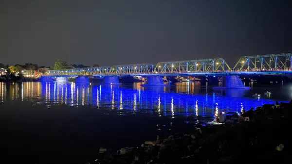 the bridge at night, lit up in blue color