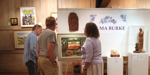people gazing at art inside the mill
