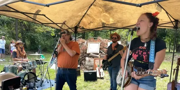 a band performing under a tent outdoors