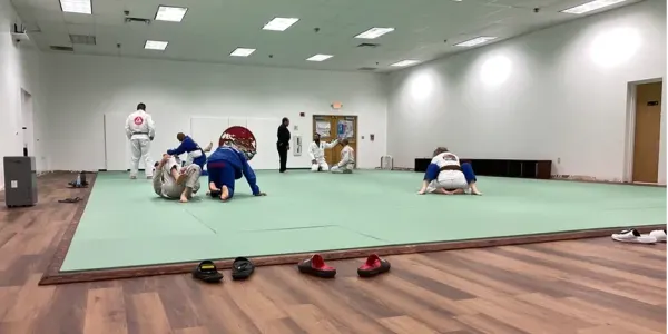 martial arts students practicing on an open mat