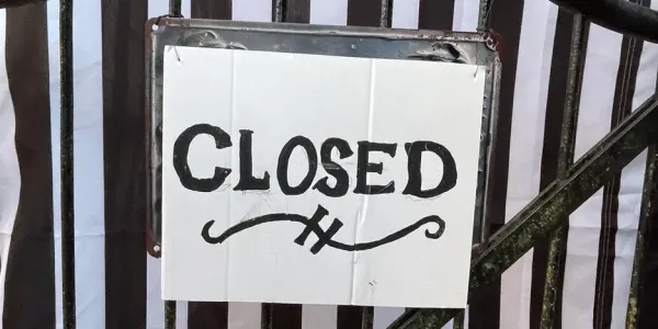 a fancy, hand-written sign that says closed