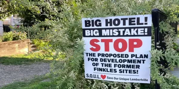 a lawn sign that reads, "Big hotel! Big Mistake! STOP the proposed plan for redevelopment of the former Finkles sites!"