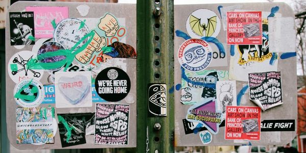 counter-culture stickers on the back of a sign in Lambertville, NJ