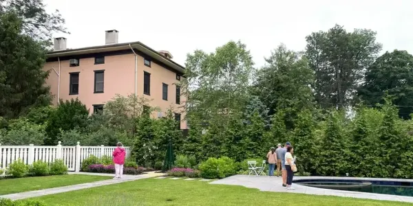 people standing near a pool in a well-designed backyard