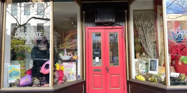 posters in the window of a quaint chocolate shop