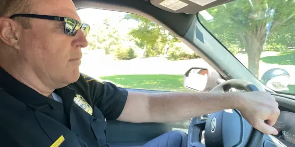 Lt. Robert Brown driving in a police cruiser