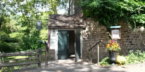 an open door on an old, stone mill building