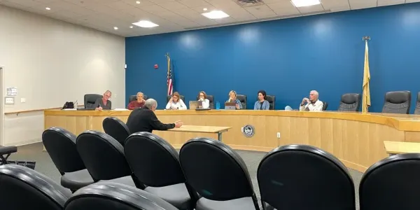 a man sits at a table before the Historic Preservation Committee